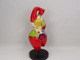 a figurine of a clown on a black stand