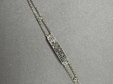 a close up of a silver bracelet on a table