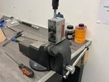 an image of a clamp on a workbench in a workshop