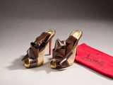 pair of women ' s shoes and a red bag on a white surface