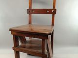 a wooden chair that is sitting on a white floor