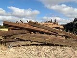 a pile of wood sitting in the middle of a field