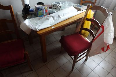 a wooden table with a red chair next to it