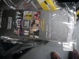 a book in a plastic bag on the seat of a bus