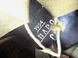 a close up of a person wearing a hat with a label on it