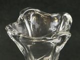 a glass vase with a flower inside of it