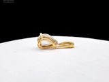 a close up of a gold ring with a pear shaped diamond