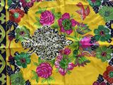 brightly colored scarf with a floral design on a yellow background