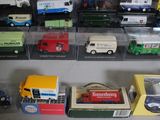 many different types of toy trucks on display in a case