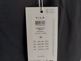 the label is attached to the back of a black dress