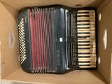 an accordion in a cardboard box sitting on top of a table
