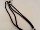 a black cord with a silver clasp on it