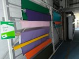 a rack with a bunch of different colored sheets on it
