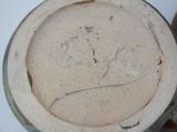 a close up of a vase with writing on it