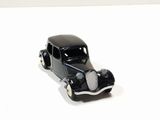 a black toy car sitting on a white surface