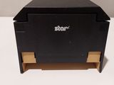 a close up of a small black box on a white surface