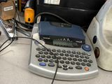 a typewriter sitting on a desk next to a computer monitor