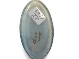 an oval shaped glass object with a sticker on it ' s side