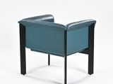 the back of a blue leather chair with a black metal frame