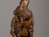 bronze statue of a boy and a girl on a rock
