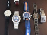 a lot of watches that are sitting on a table