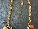 a gold chain bracelet with heart charms and charms on it