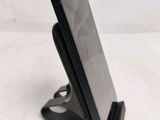 a cell phone that is on a stand on a table