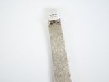 a silver tie with a tag on it on a white surface