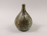 a small vase with a hole in the middle of it