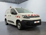citroen van with red and white stripes parked in a large room