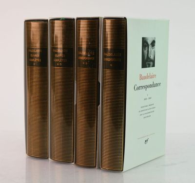 three books sitting on top of a white table next to each other