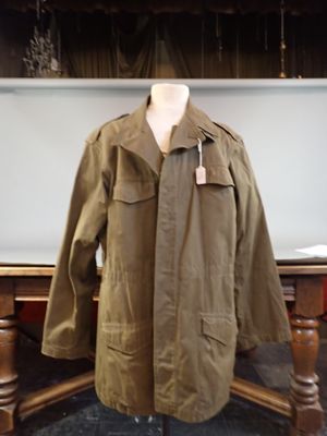 jacket on a mannequin stand in front of a table