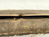 a close up of a piece of wood with rust on it