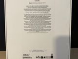 the back of a white box with a green sticker on it