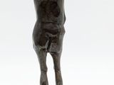 statue of a woman with a hat on her head standing on a base