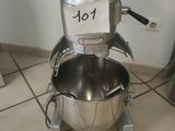 a mixer sitting on the floor in the kitchen