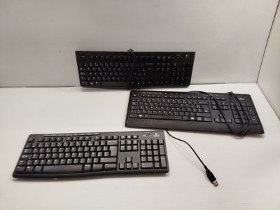 two keyboards and a mouse sitting on a table