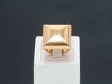 a close up of a gold ring on top of a white box