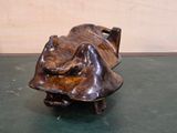 a bronze sculpture of a man sleeping on a bench