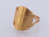 a close up of a gold ring on a white surface
