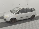 a small white car that is parked in a garage