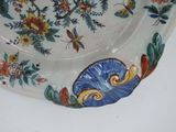 a plate with a floral design on it sitting on a table