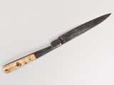 a knife with a wooden handle on a white surface