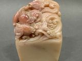a soap that is shaped like a dragon on a block of soap