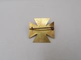 a close up of a gold cross on a white surface