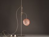 floor lamp with a metal base and a pink glass ball hanging from it ' s side