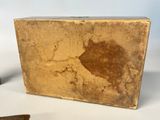 a small wooden box that has a piece of paper on it