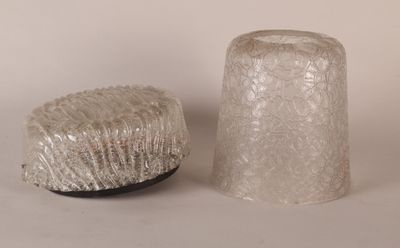 two glass vases sitting next to each other on a table