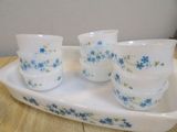 four cups and a tray on a wooden table