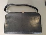 an image of a black purse on a table